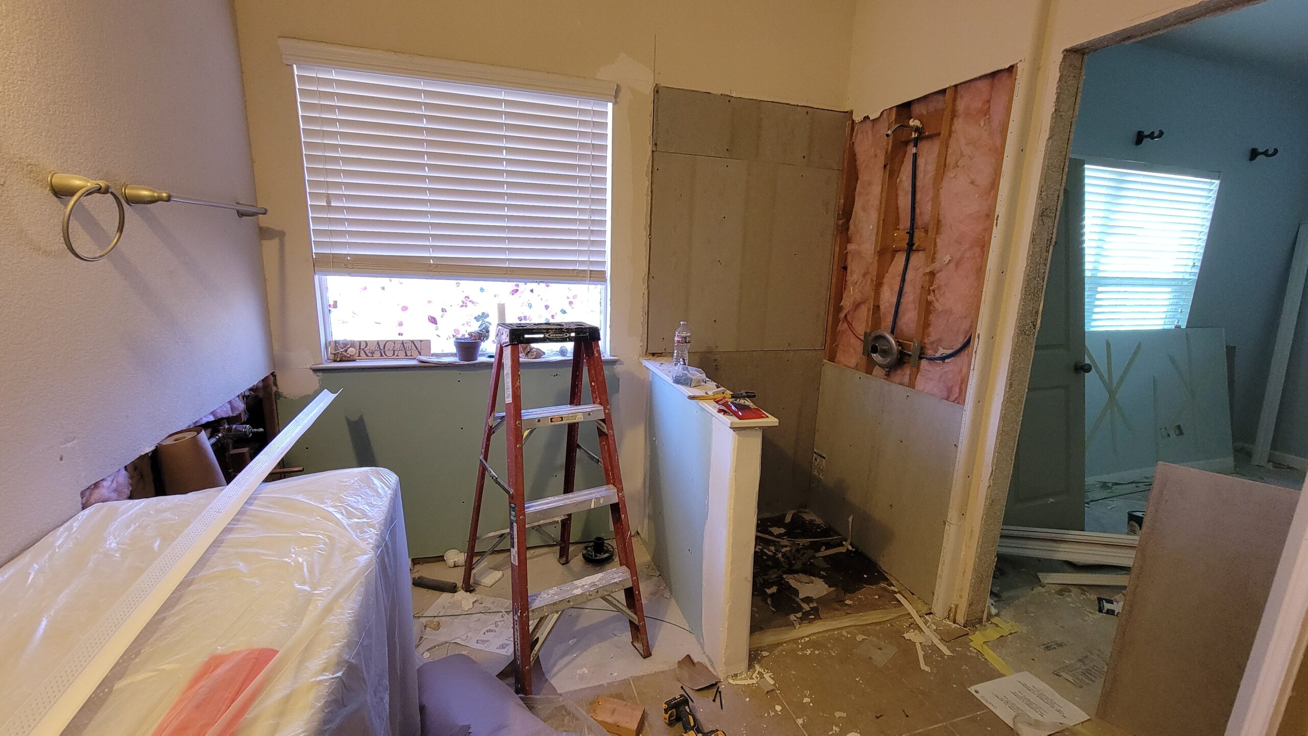 Experienced Austin TX remodeling contractor Cuatro Pilares performing bathroom demolition and preparation for full renovation with exposed plumbing and framing
