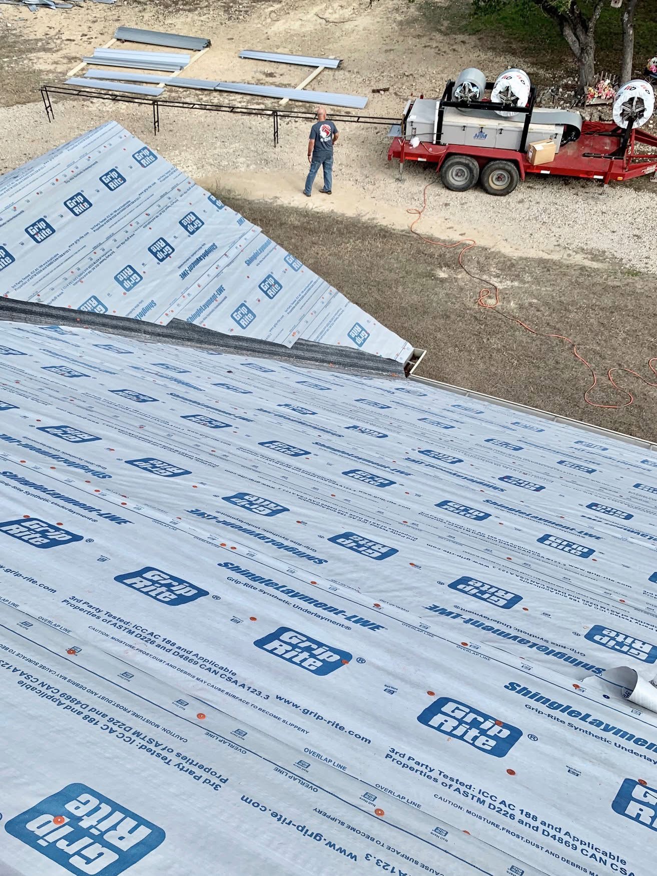 Experienced Austin TX roofing contractor Cuatro Pilares installing synthetic roof underlayment for waterproof protection before metal roofing installation
