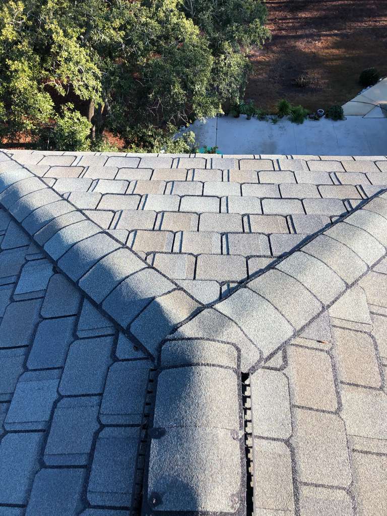 Experienced Austin TX roofing contractor Cuatro Pilares installing hip and ridge shingles with precision for durable and weather-resistant roof system