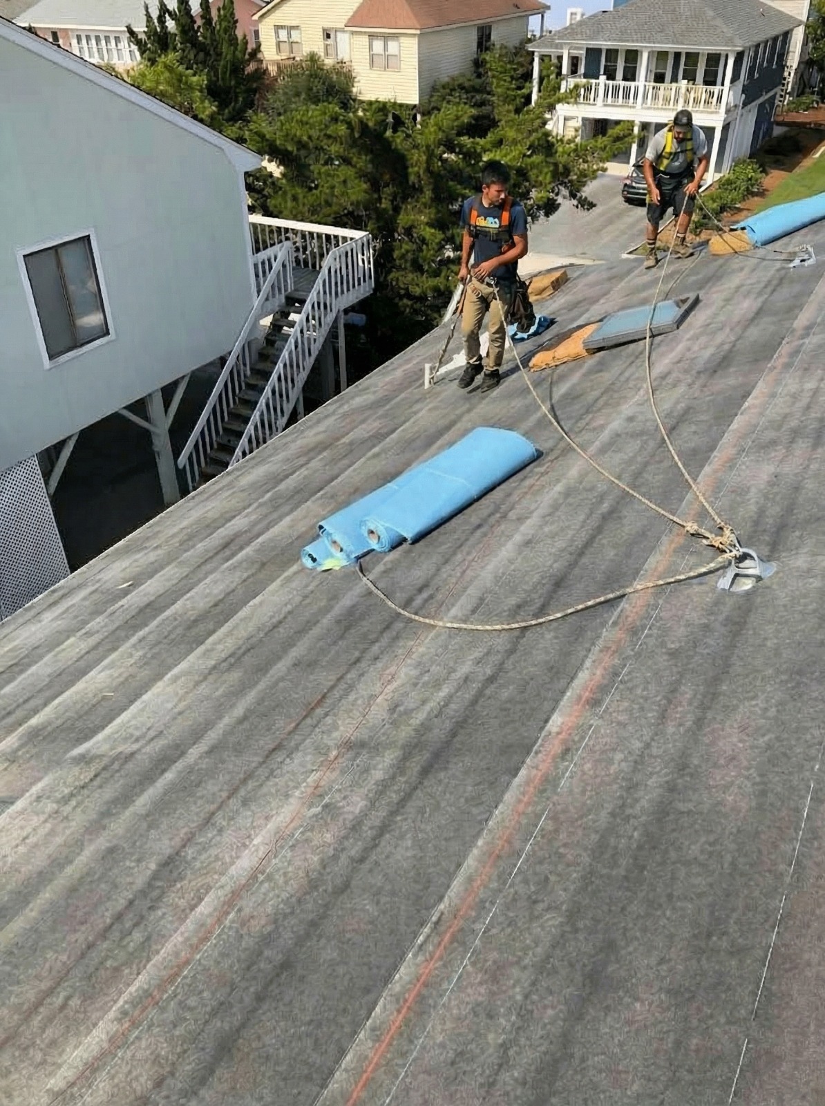 Experienced Austin TX roofing contractor Cuatro Pilares crew performing roof tear-off and preparation work for residential roof replacement