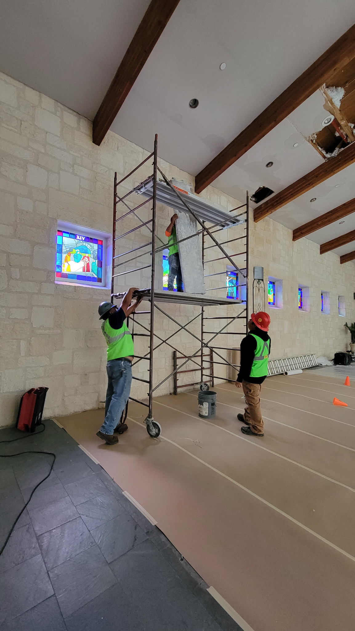 Professional Cuatro Pilares crew completing church remodeling project in Austin TX using scaffolding and drywall installation